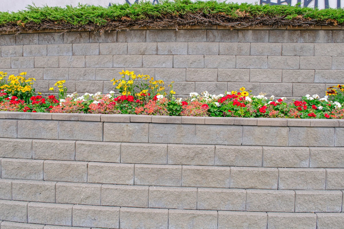 A retaining wall protecting a residential yard from erosion