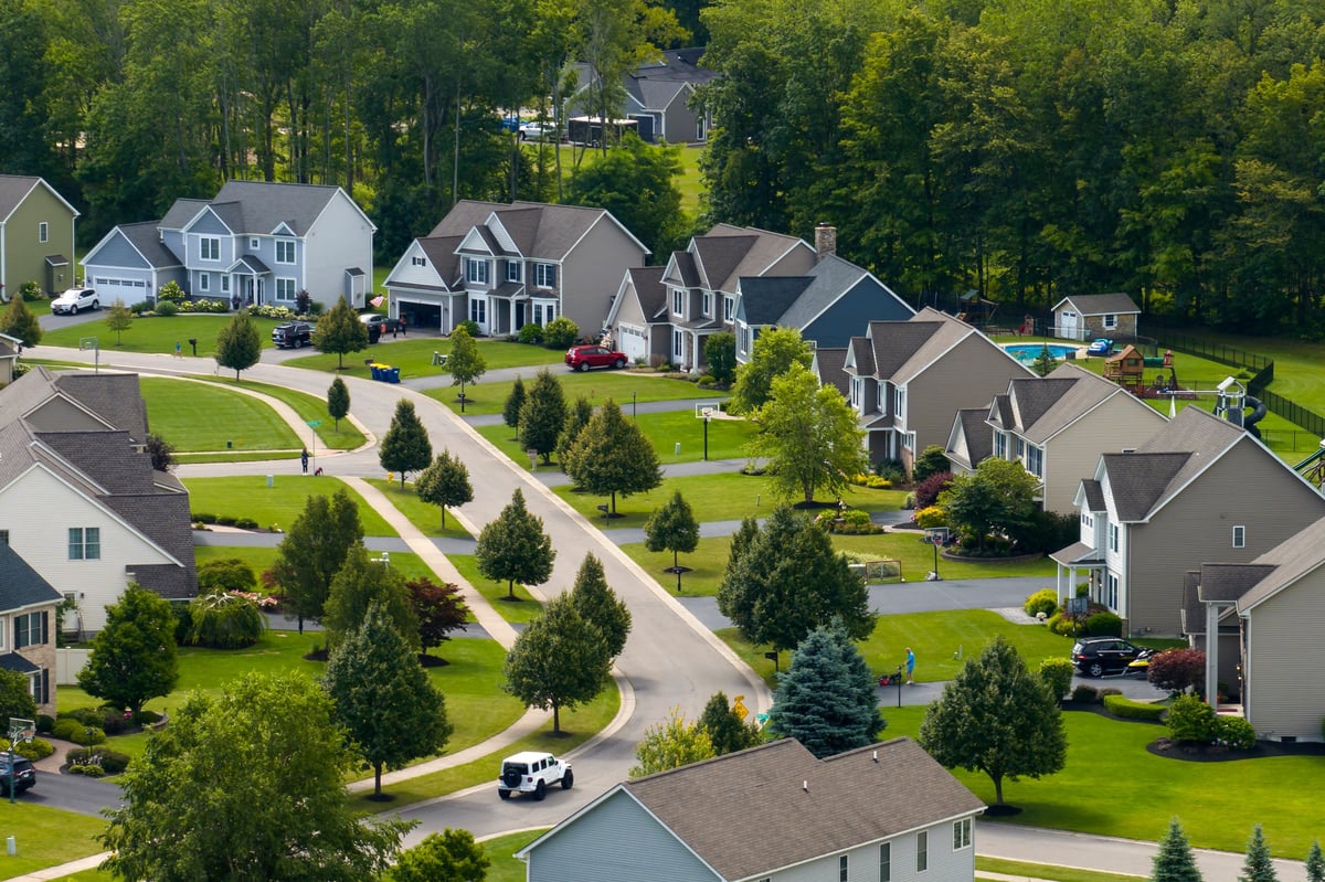 Traditional planned neighborhood of single family homes with green lawns and trees on Snoqualmie Ridge