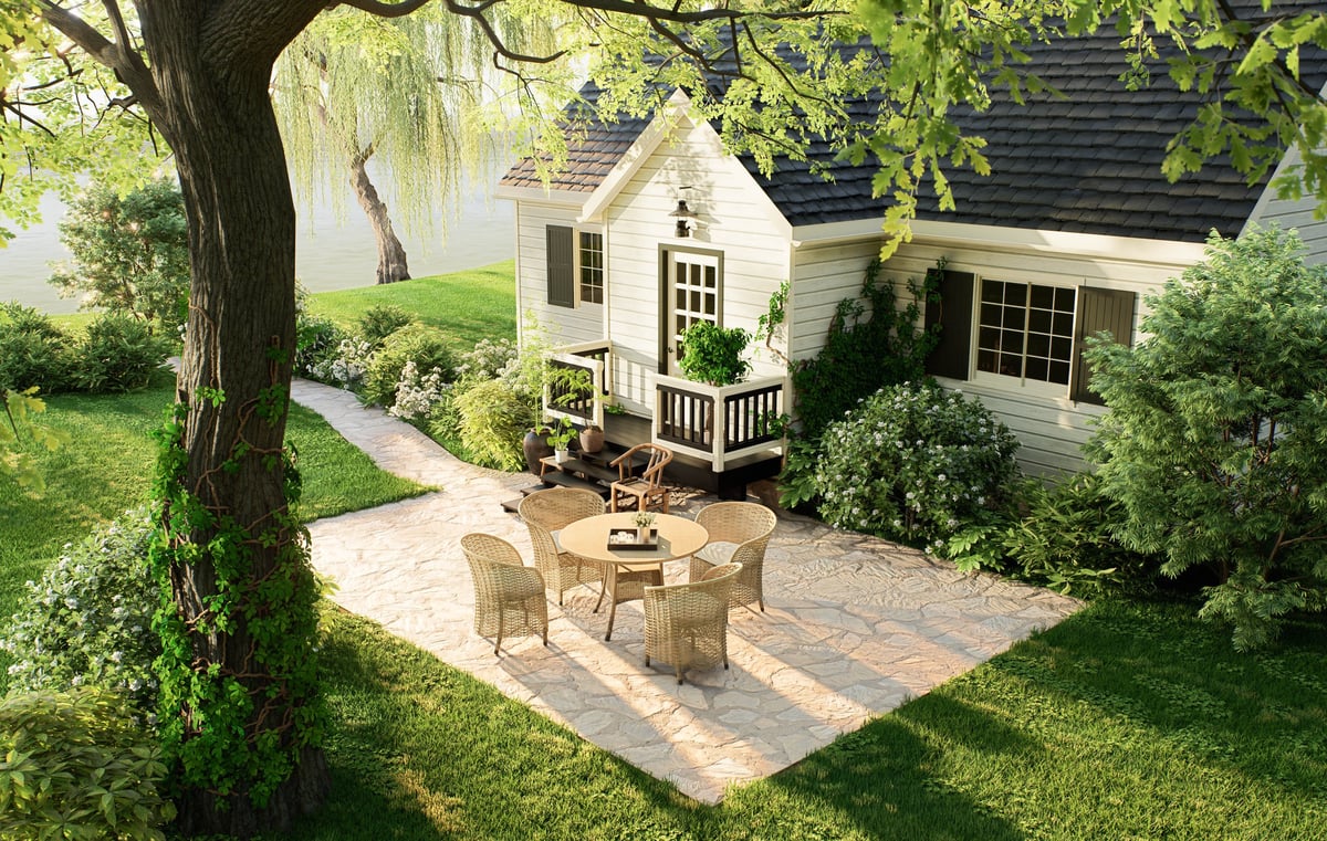 Backyard with a stone patio, green lawn and a lake nearby in a Covington neighborhood